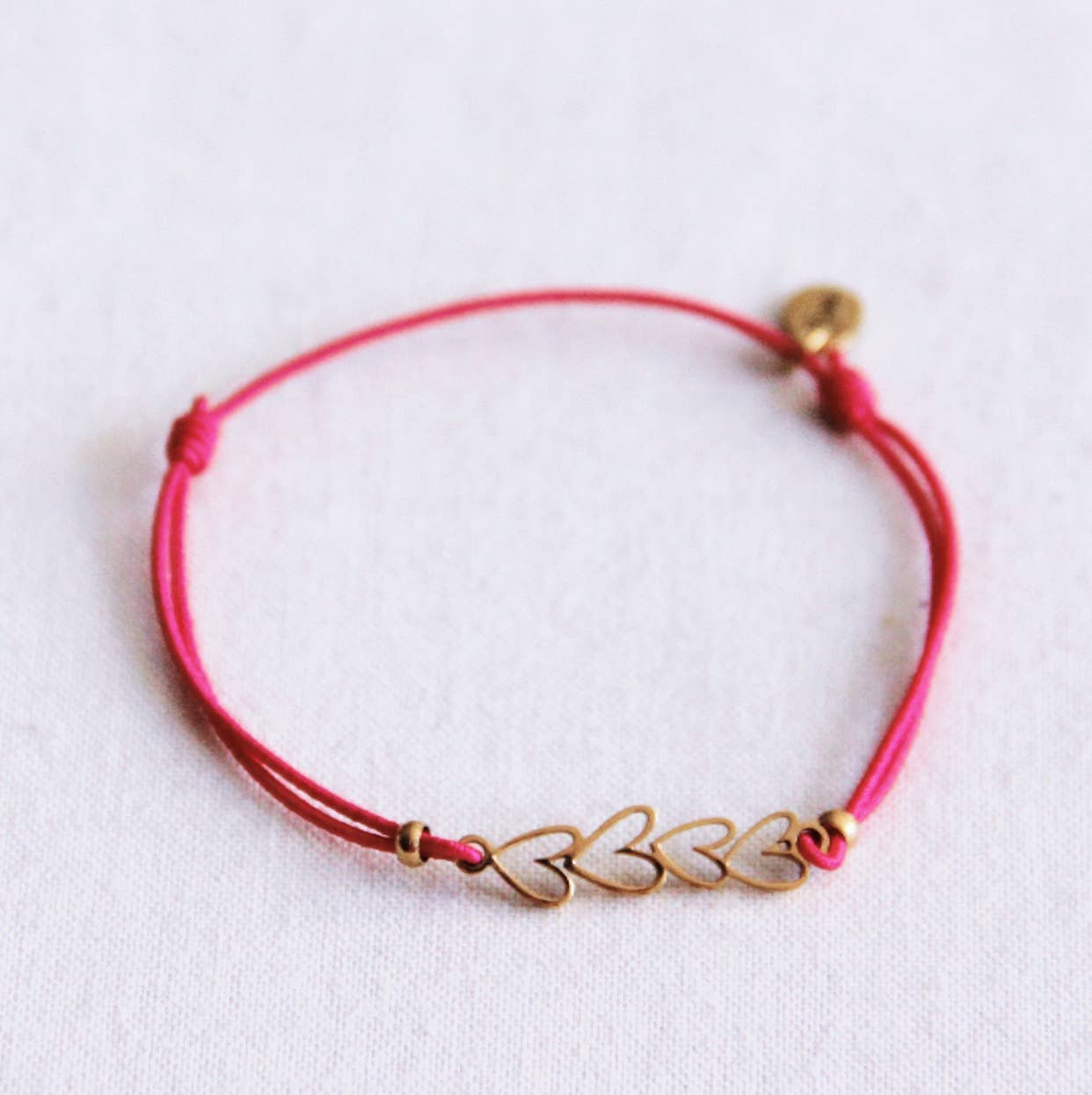 Elastische armband met open harten - fuchsia